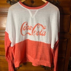 Red and white Coca-cola shirt.